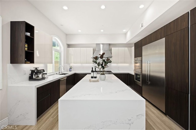 1279 Waterbrook Cir, Walnut, CA 91789 - kitchen featuring modern cabinets, stainless steel appliances, wall chimney range hood, a kitchen island, and recessed lighting