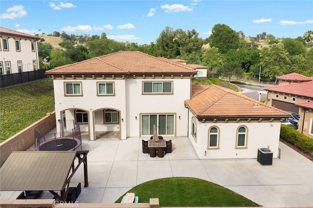 1279 Waterbrook Cir, Walnut, CA 91789 - back of house featuring central AC, stucco siding, a fenced backyard, a patio area, and a tiled roof