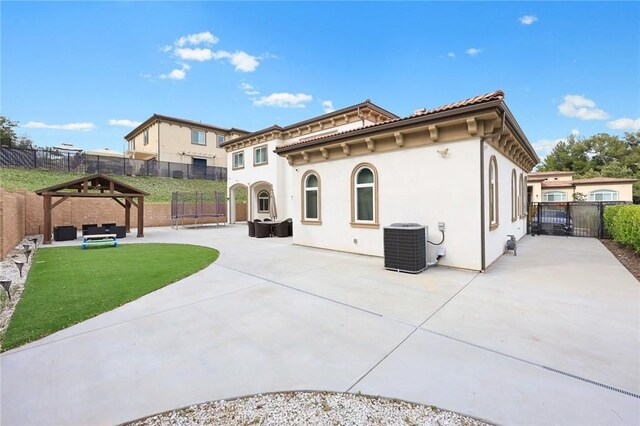 1279 Waterbrook Cir, Walnut, CA 91789 - rear view of house with a patio area, central AC unit, a gate, and stucco siding