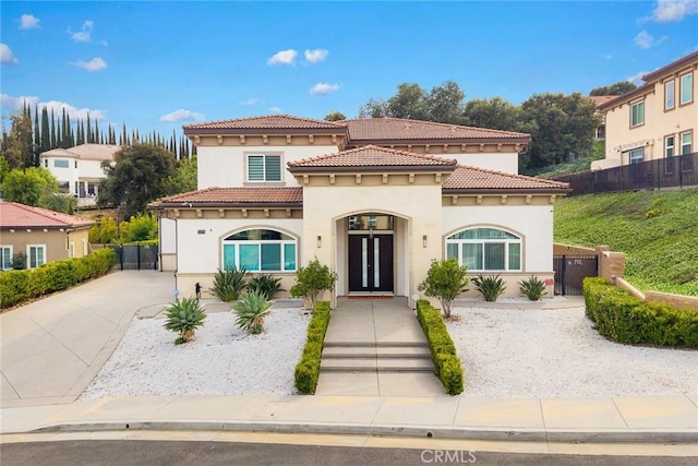 1279 Waterbrook Cir, Walnut, CA 91789 - mediterranean / spanish-style house featuring stucco siding, a gate, and a tiled roof