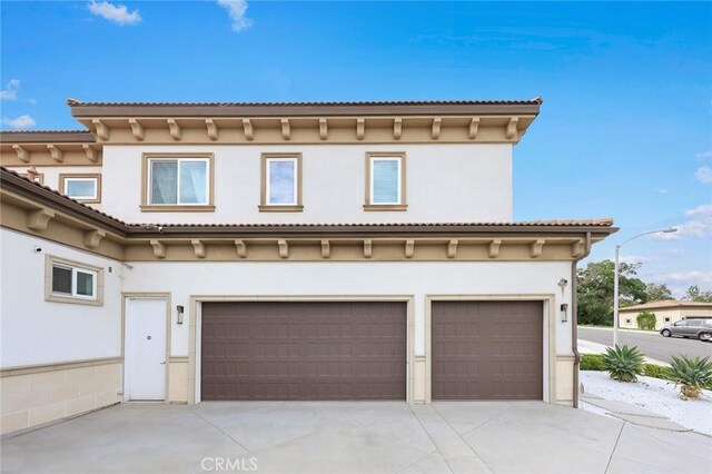1279 Waterbrook Cir, Walnut, CA 91789 - view of front of property featuring concrete driveway, a garage, and stucco siding
