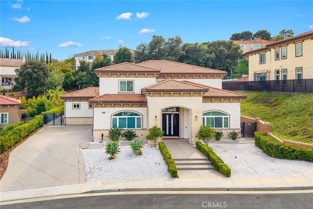 1279 Waterbrook Cir, Walnut, CA 91789 - mediterranean / spanish-style home featuring stucco siding, a tile roof, a gate, and concrete driveway