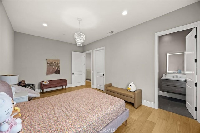 1279 Waterbrook Cir, Walnut, CA 91789 - bedroom with baseboards, light wood-style flooring, recessed lighting, a chandelier, and connected bathroom