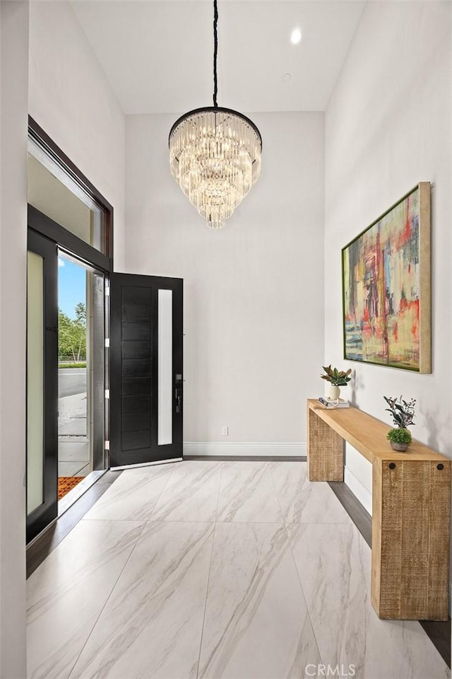 1279 Waterbrook Cir, Walnut, CA 91789 - entrance foyer featuring a chandelier, marble look tiles, a towering ceiling, and baseboards