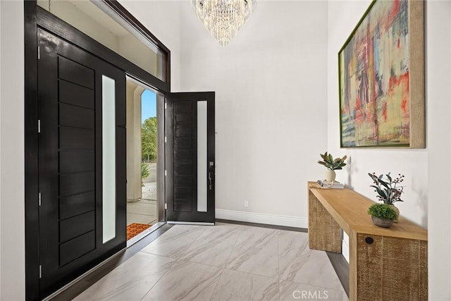 1279 Waterbrook Cir, Walnut, CA 91789 - entrance foyer featuring baseboards, marble look tile flooring, a chandelier, and a towering ceiling