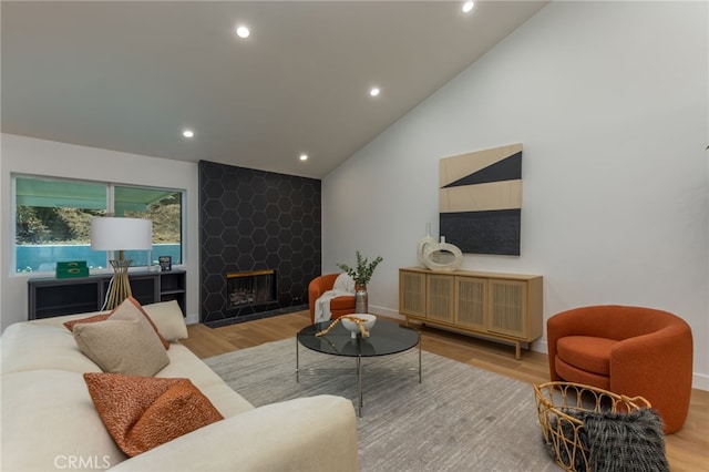 876 Ballina Ct, Newbury Park, CA 91320 - living room featuring wood finished floors, recessed lighting, lofted ceiling, a large fireplace, and baseboards