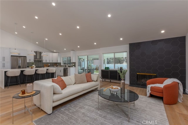 876 Ballina Ct, Newbury Park, CA 91320 - living area with light wood finished floors, a fireplace, recessed lighting, and lofted ceiling