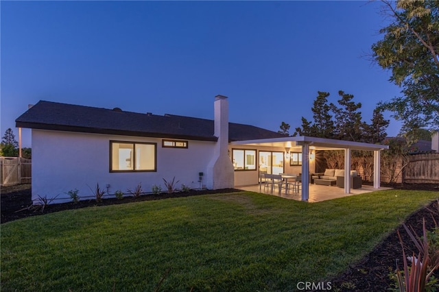 876 Ballina Ct, Newbury Park, CA 91320 - back of house with an outdoor living space, a chimney, a patio area, and stucco siding