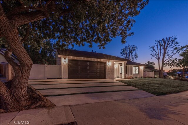 876 Ballina Ct, Newbury Park, CA 91320 - view of front of property with driveway, an attached garage, and brick siding