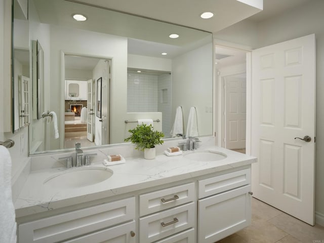 1695 Alta La Jolla Dr, La Jolla, CA 92037 - bathroom with double vanity, recessed lighting, a lit fireplace, and tile patterned floors