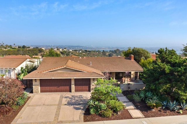 1695 Alta La Jolla Dr, La Jolla, CA 92037 - view of front facade with a tiled roof, driveway, a garage, stone siding, and a chimney