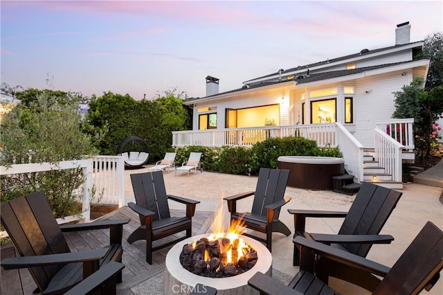 425 Tustin Ave, Newport Beach, CA 92663 - patio terrace at dusk with an outdoor fire pit, a hot tub, a patio area, and a deck