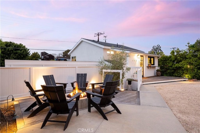 425 Tustin Ave, Newport Beach, CA 92663 - patio terrace at dusk featuring a fire pit and a wooden deck