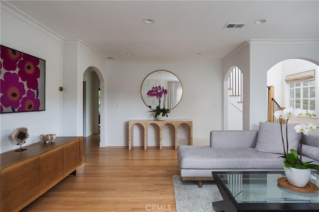 425 Tustin Ave, Newport Beach, CA 92663 - living room featuring arched walkways, light wood finished floors, crown molding, and recessed lighting