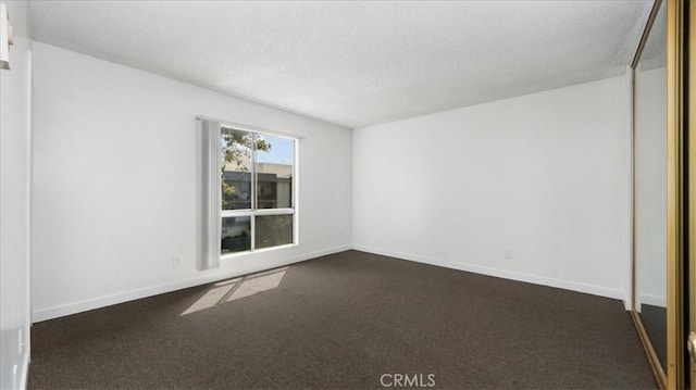 3649 Glendon Ave Unit 202, Los Angeles, CA 90034 - unfurnished room with a textured ceiling, dark colored carpet, and baseboards