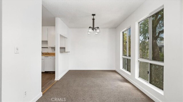3649 Glendon Ave Unit 202, Los Angeles, CA 90034 - unfurnished dining area with a chandelier, dark carpet, and baseboards