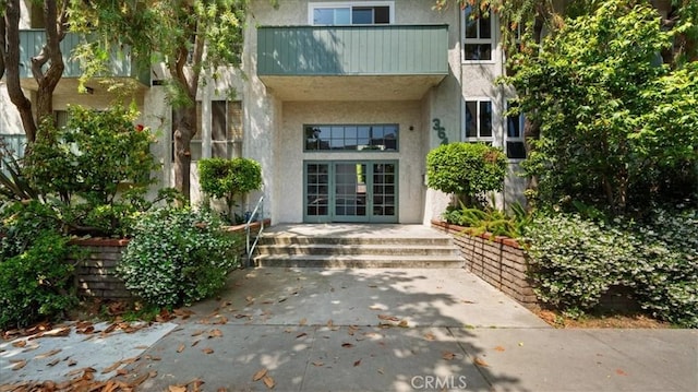 3649 Glendon Ave Unit 202, Los Angeles, CA 90034 - doorway to property with stucco siding, french doors, and a balcony