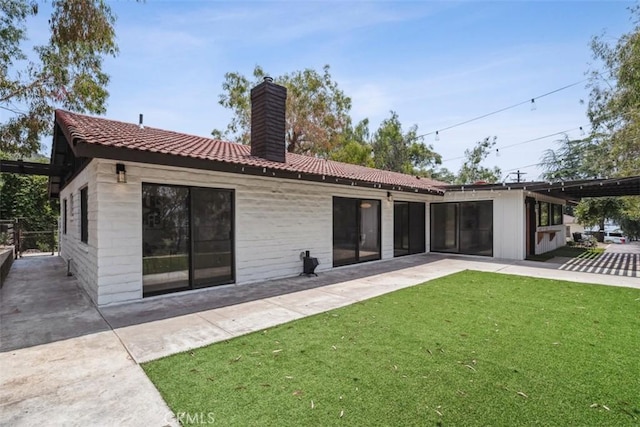 11707 Pendleton Rd, Yucaipa, CA 92399 - rear view of house with a chimney, a lawn, a patio area, and a tile roof