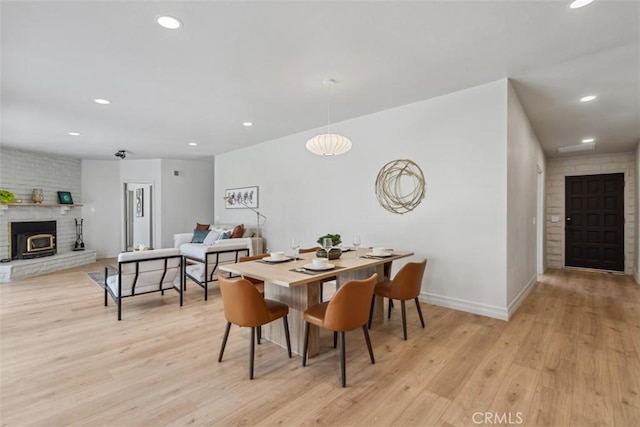 11707 Pendleton Rd, Yucaipa, CA 92399 - dining room with light wood finished floors, a brick fireplace, and recessed lighting