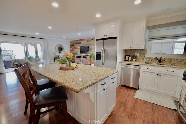 7642 Rhone Ln, Huntington Beach, CA 92647 - kitchen with appliances with stainless steel finishes, a sink, healthy amount of natural light, open floor plan, and ornamental molding