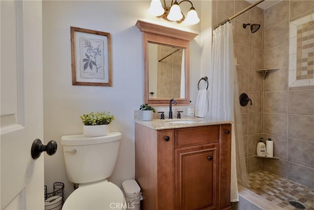 7642 Rhone Ln, Huntington Beach, CA 92647 - bathroom with toilet, vanity, a tile shower, and a chandelier