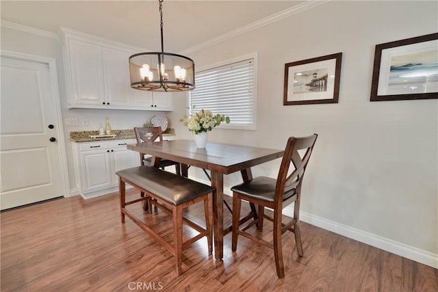 7642 Rhone Ln, Huntington Beach, CA 92647 - dining space featuring a chandelier, light wood finished floors, crown molding, and baseboards