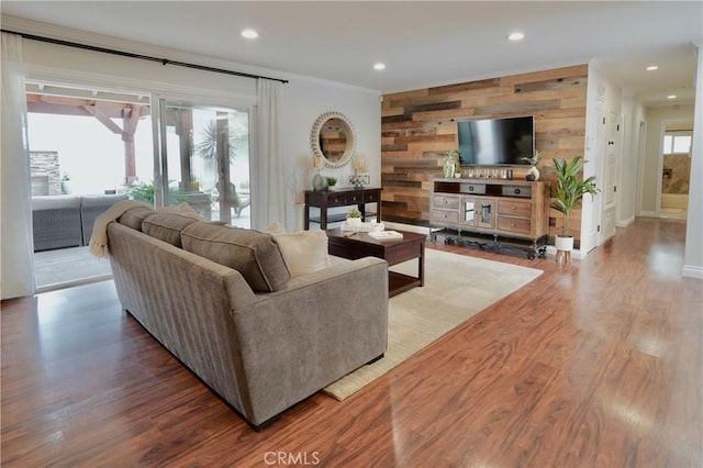 7642 Rhone Ln, Huntington Beach, CA 92647 - living area with wood finished floors, recessed lighting, wood walls, crown molding, and baseboards