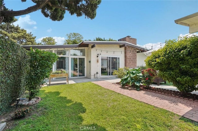 1721 S 3rd Ave, Arcadia, CA 91006 - back of property with stucco siding, a chimney, and a lawn