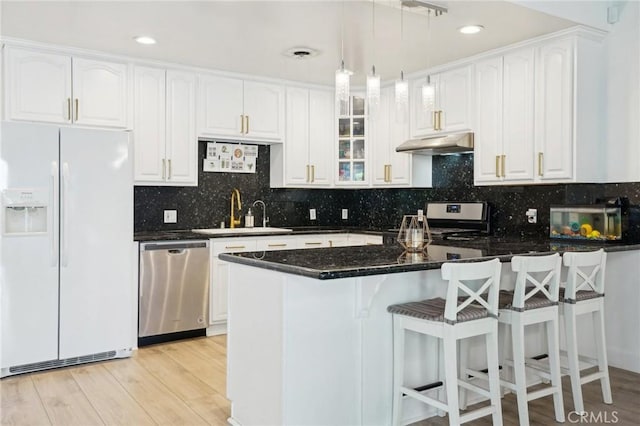 1721 S 3rd Ave, Arcadia, CA 91006 - kitchen featuring appliances with stainless steel finishes, a sink, under cabinet range hood, light wood-type flooring, and white cabinets
