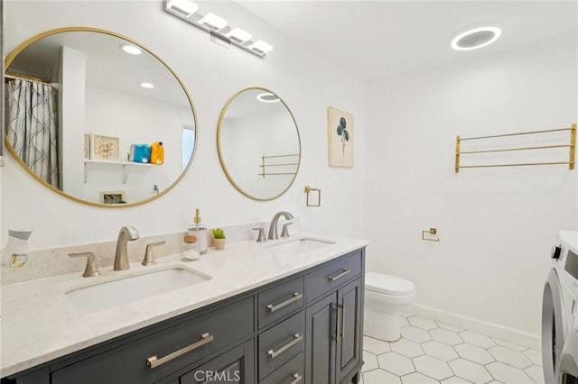 1721 S 3rd Ave, Arcadia, CA 91006 - bathroom featuring double vanity, toilet, washer and dryer, tile patterned flooring, and baseboards