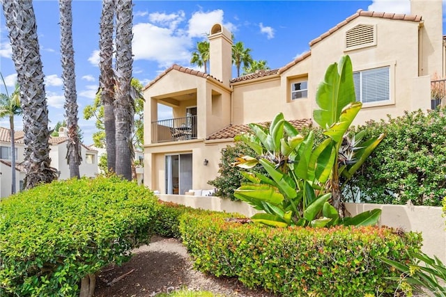 3 Fleurance St, Laguna Niguel, CA 92677 - rear view of property with a balcony, a tiled roof, stucco siding, and a chimney
