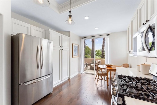 3 Fleurance St, Laguna Niguel, CA 92677 - kitchen featuring appliances with stainless steel finishes, white cabinets, dark wood finished floors, recessed lighting, and decorative light fixtures