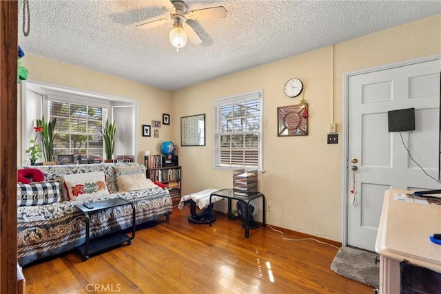 602 Stanley Ave, Long Beach, CA 90814 - living room with healthy amount of natural light, a textured ceiling, ceiling fan, and wood finished floors