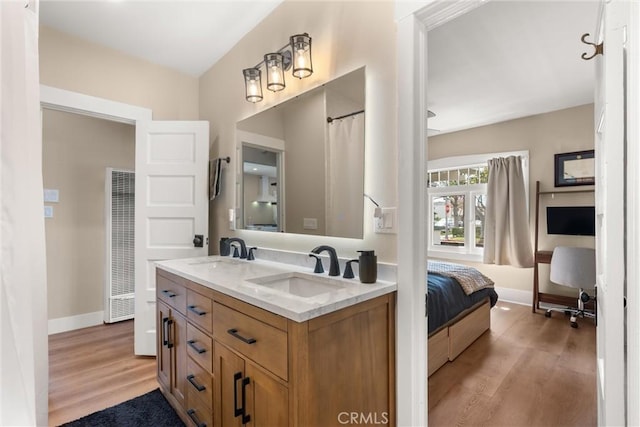 602 Stanley Ave, Long Beach, CA 90814 - bathroom with double vanity, a heating unit, wood finished floors, and baseboards