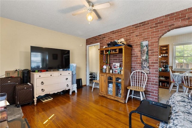 602 Stanley Ave, Long Beach, CA 90814 - living area featuring wood finished floors, ceiling fan, a textured ceiling, and arched walkways