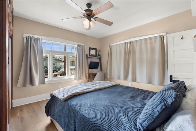 602 Stanley Ave, Long Beach, CA 90814 - bedroom with baseboards, wood finished floors, and ceiling fan