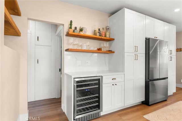 602 Stanley Ave, Long Beach, CA 90814 - indoor dry bar featuring freestanding refrigerator, beverage cooler, light wood finished floors, and recessed lighting