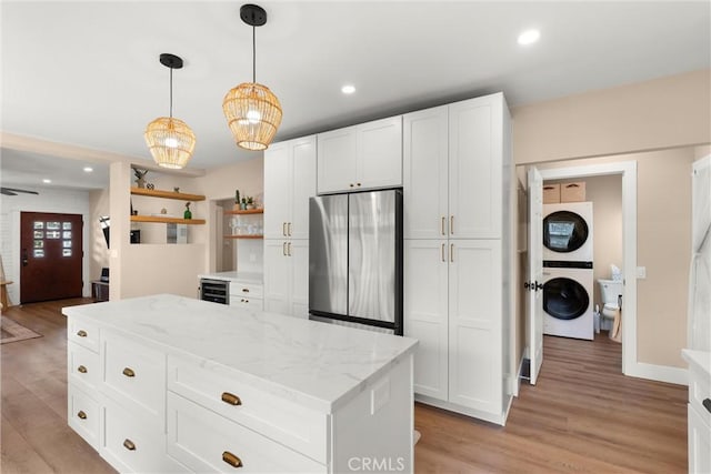 602 Stanley Ave, Long Beach, CA 90814 - kitchen with freestanding refrigerator, stacked washer and clothes dryer, wine cooler, light wood-style flooring, and white cabinets