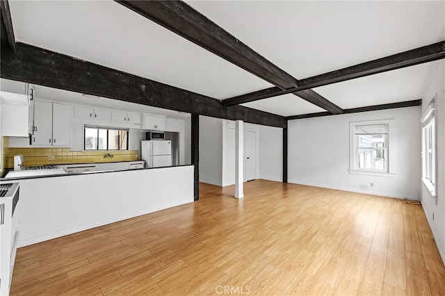 1634 Bayview Dr, Hermosa Beach, CA 90254 - unfurnished living room featuring light wood-style flooring and beamed ceiling