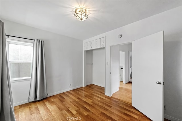 1634 Bayview Dr, Hermosa Beach, CA 90254 - unfurnished bedroom featuring light wood-style flooring and a closet