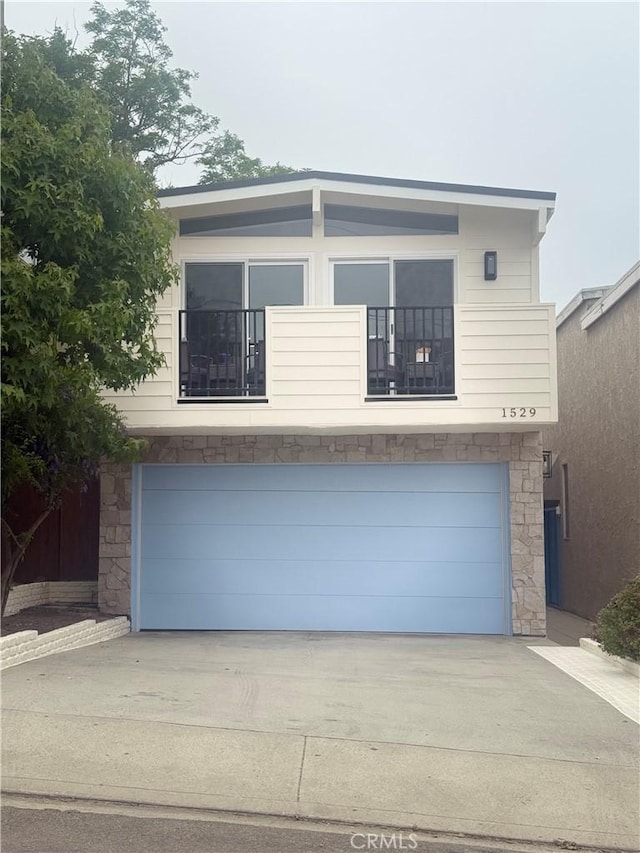 1529 Steinhart Ave, Redondo Beach, CA 90278 - view of front of home featuring stone siding, an attached garage, and concrete driveway