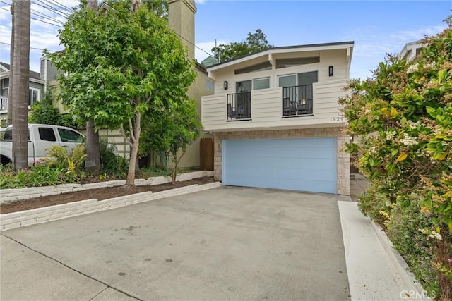 1529 Steinhart Ave, Redondo Beach, CA 90278 - view of front of property with a balcony, stone siding, a garage, concrete driveway, and a chimney