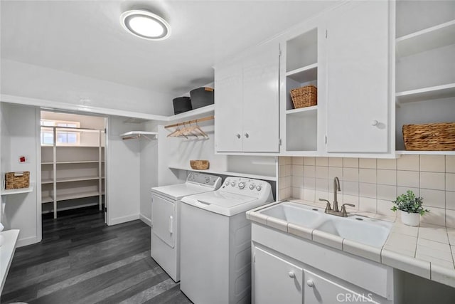 1000 Park Ave, Cayucos, CA 93430 - laundry area featuring separate washer and dryer, cabinet space, dark wood-style floors, and baseboards