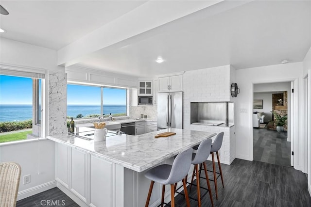 1000 Park Ave, Cayucos, CA 93430 - kitchen featuring stainless steel appliances, a peninsula, a water view, baseboards, and recessed lighting