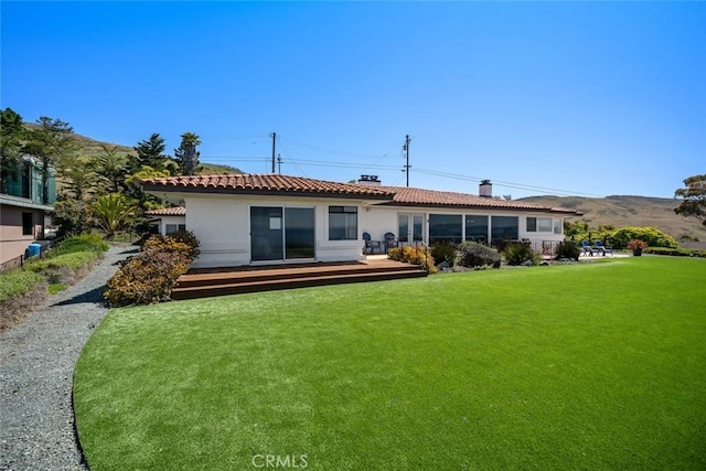 1000 Park Ave, Cayucos, CA 93430 - back of property with a chimney, a lawn, stucco siding, a deck, and a tile roof