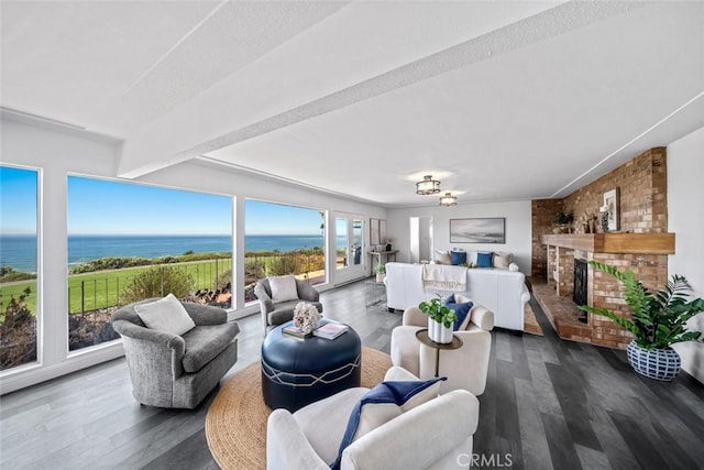 1000 Park Ave, Cayucos, CA 93430 - living room with a water view, a fireplace, wood finished floors, and a chandelier