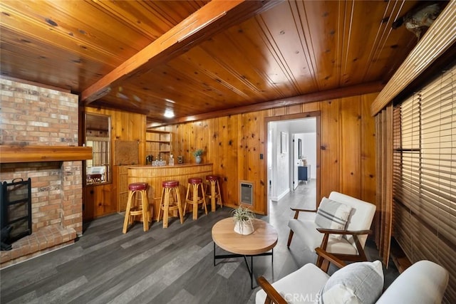1000 Park Ave, Cayucos, CA 93430 - sitting room with a bar, wood walls, a fireplace, heating unit, and wood ceiling with exposed beams