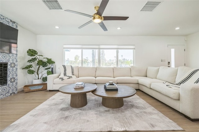 2665 E Vincentia Rd, Palm Springs, CA 92262 - living area with plenty of natural light, ceiling fan, wood finished floors, recessed lighting, and a tiled fireplace