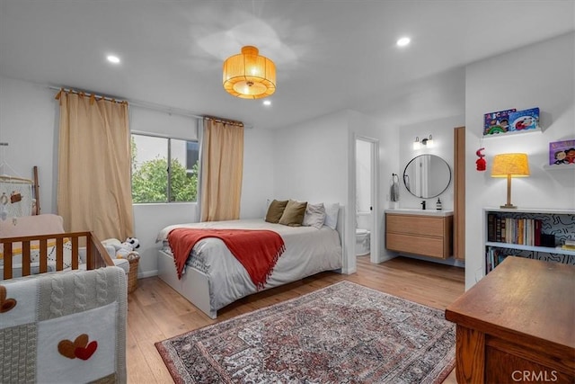 5465 Newcastle Ave Unit 6, Encino, CA 91316 - bedroom featuring light wood-style flooring, recessed lighting, and connected bathroom