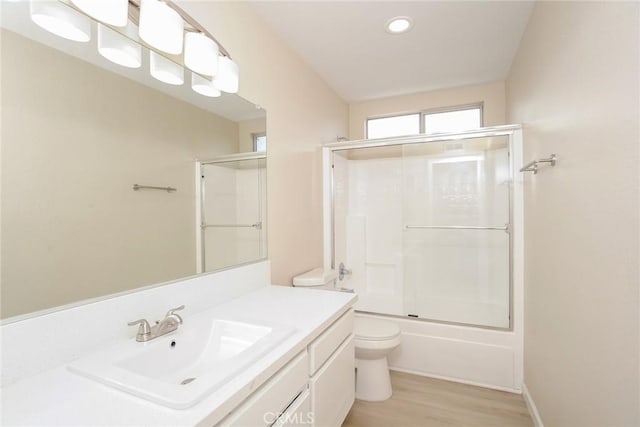 44124 Sundance Ct, Lancaster, CA 93535 - bathroom with toilet, vanity, enclosed tub / shower combo, wood finished floors, and recessed lighting